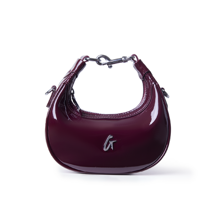 Glossy burgundy hobo bag with a sleek design and silver hardware, perfect for stylish everyday use.