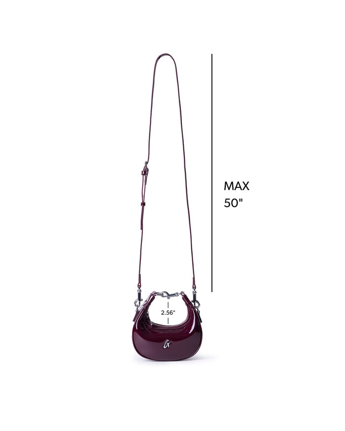 Burgundy hobo bag with a glossy mirror finish, featuring a stylish shoulder strap and sleek design.