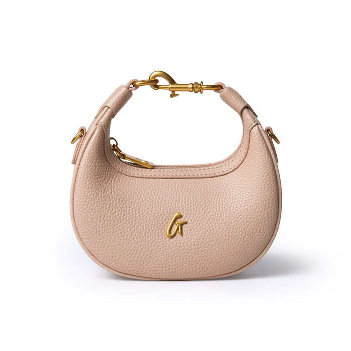 Nude Nano Pebble Hobo Bag with gold hardware, curved shape, textured leather, and a gold "G" logo on the front.