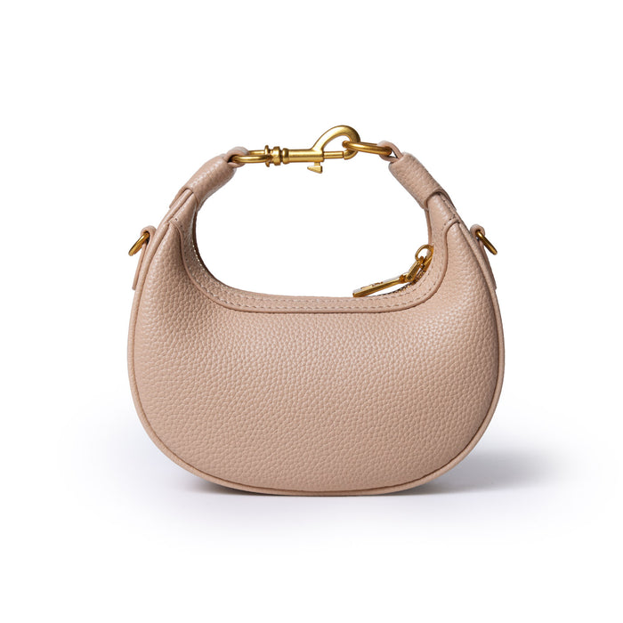 Nude Nano Pebble Hobo Bag with textured leather, gold hardware, and a curved, compact design.