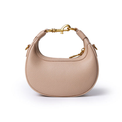 Nude Nano Pebble Hobo Bag with textured leather, gold hardware, and a curved, compact design.