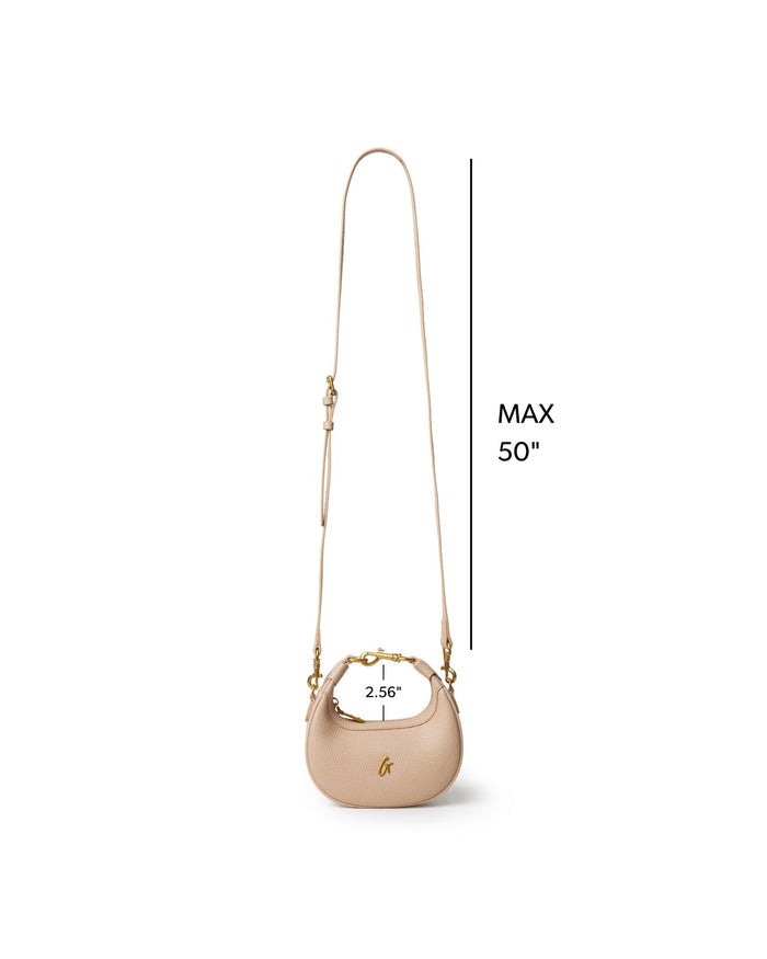 NANO PEBBLE HOBO BAG in nude with a stylish curved shape and adjustable strap for versatile wear.