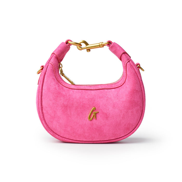 Hot pink nano suede hobo bag with a gold clasp and logo, perfect for adding a pop of color to any outfit.