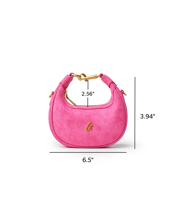 Hot pink nano suede hobo bag with gold hardware, featuring a curved silhouette and stylish design for everyday use.