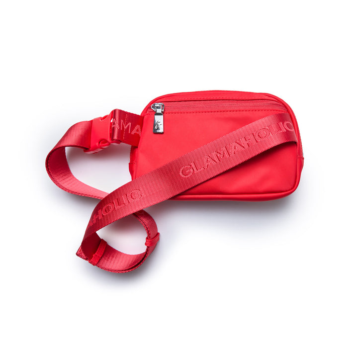 Red nylon fanny pack with adjustable strap, front zipper pocket, and branded strap detail.