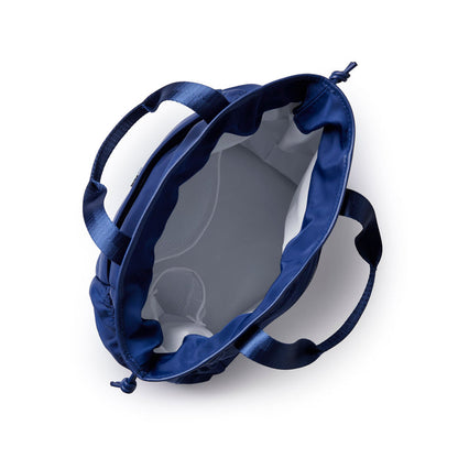 Navy nylon lunch bag with a spacious interior and sturdy handles for easy carrying and stylish storage.