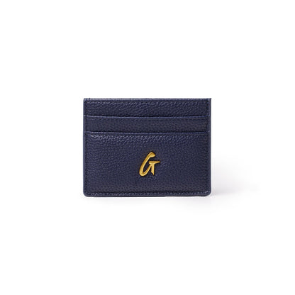Navy pebble leather card holder with gold "G" logo and multiple card slots, compact and stylish accessory.