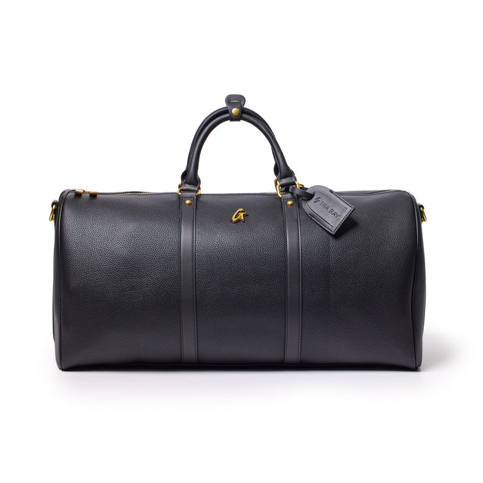 Black Pebble Duffle Bag with leather handles, gold accents, and a luggage tag, designed for travel and storage.