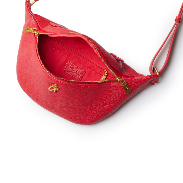 Red Pebble Fanny Pack bundle with gold zipper details and adjustable strap, open to show interior with logo patch.