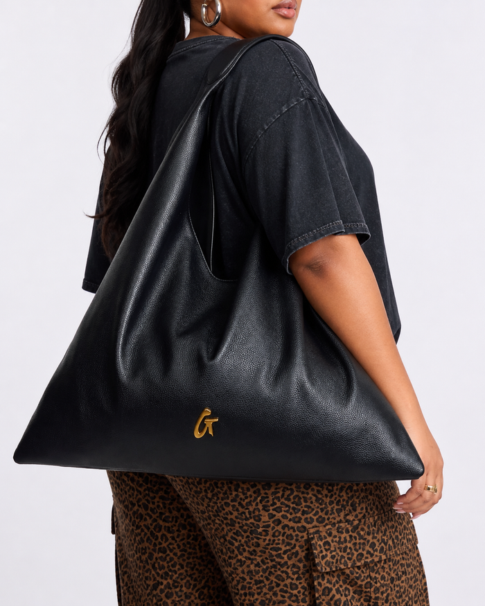 Black pebble hobo shoulder bag featuring a sleek design and gold logo, perfect for stylish everyday use.