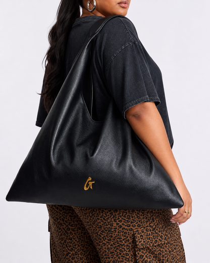 Black pebble hobo shoulder bag featuring a sleek design and gold logo, perfect for stylish everyday use.