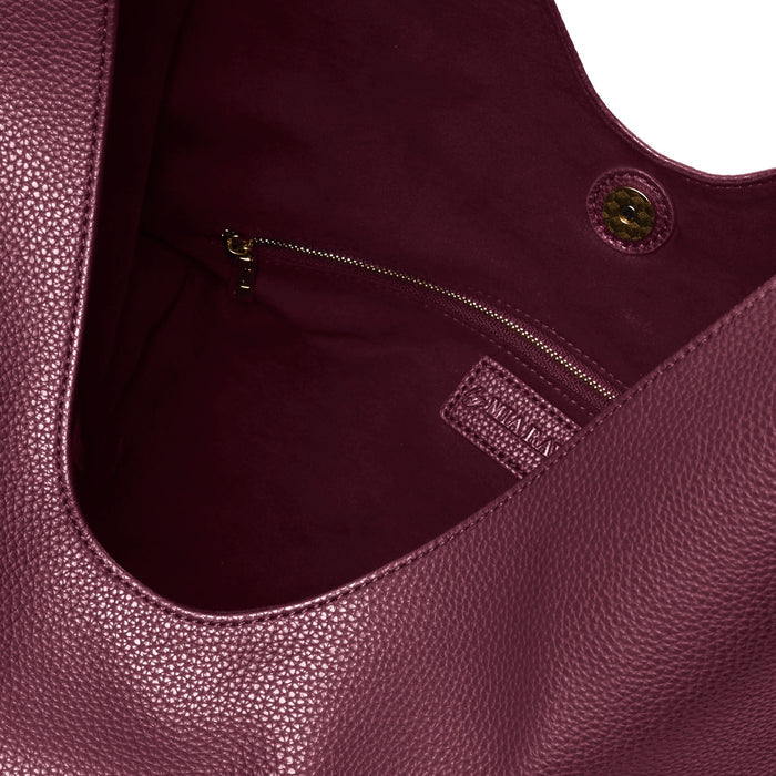 Burgundy pebble hobo shoulder bag featuring a spacious interior and zippered pocket for secure storage.