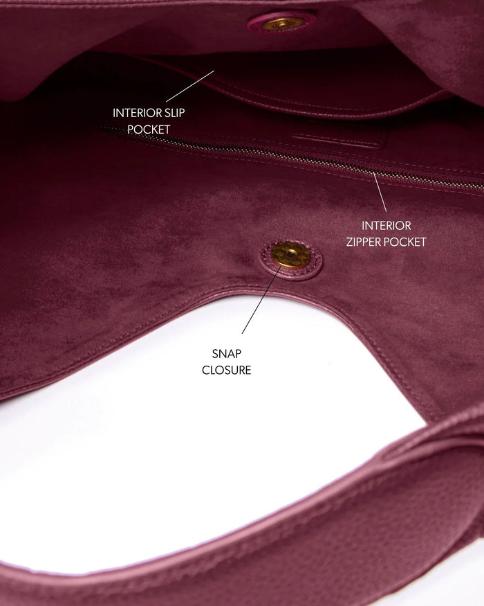 Burgundy pebble hobo shoulder bag featuring interior slip and zipper pockets, and a snap closure for secure storage.