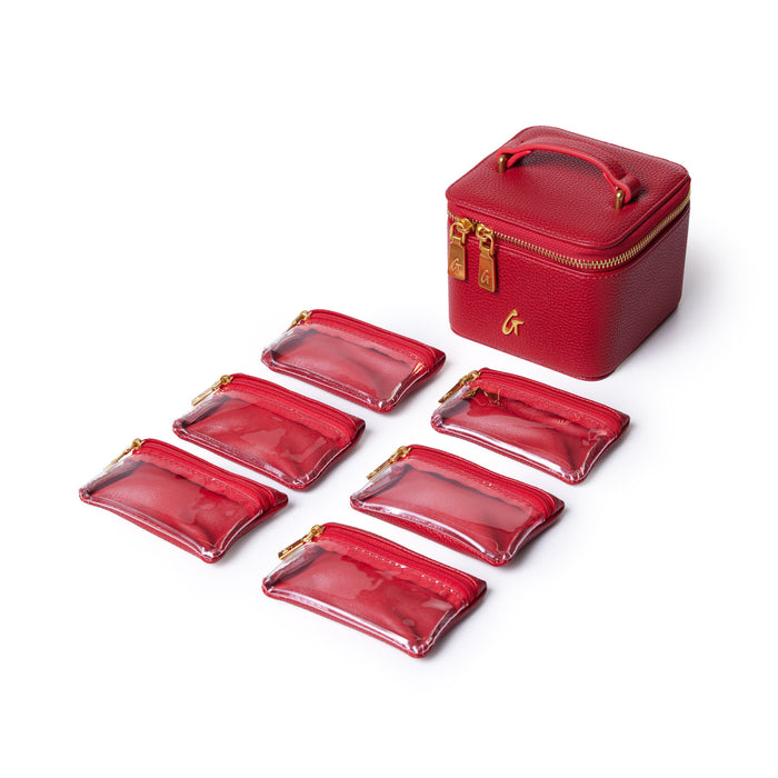 Red pebble jewelry case with a handle, gold zipper, and six matching transparent zippered pouches for organizing accessories.