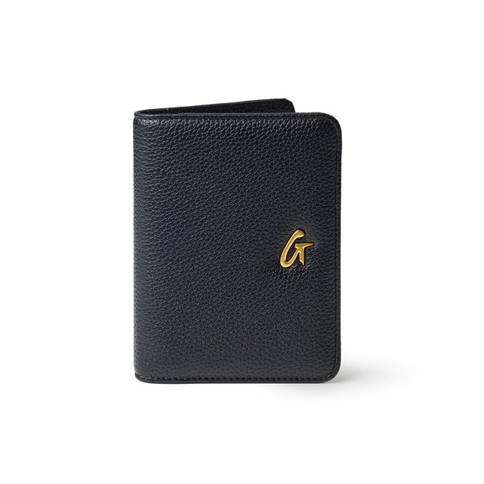 Black Pebble passport holder with a textured finish and a gold logo on the front.