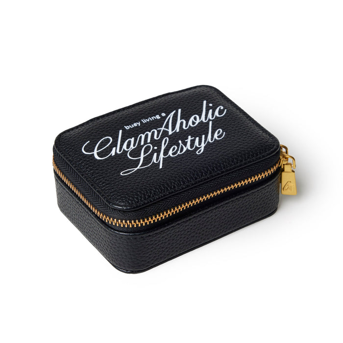 Black pebble pill case with gold zipper and Glam-Aholic Lifestyle logo, perfect for stylish organization.
