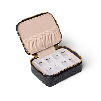 Black pebble pill case with a zippered closure, featuring a soft interior and removable weekly pill organizer.