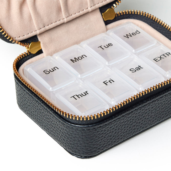 Stylish black pebble pill case with a zip closure, featuring seven clear compartments labeled for each day of the week.