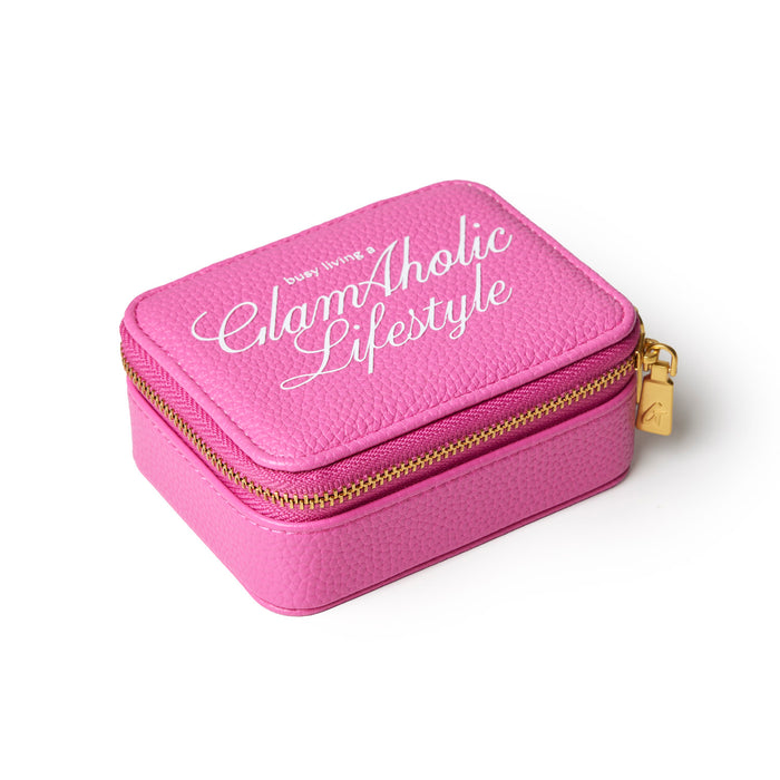 Hot pink pebble pill case with gold zipper and Glam-Aholic Lifestyle logo, perfect for stylish organization.