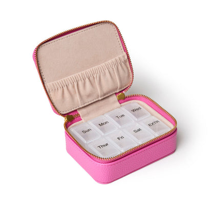 Hot pink pebble pill case with a zippered closure, featuring a soft interior and seven compartments for daily medication.
