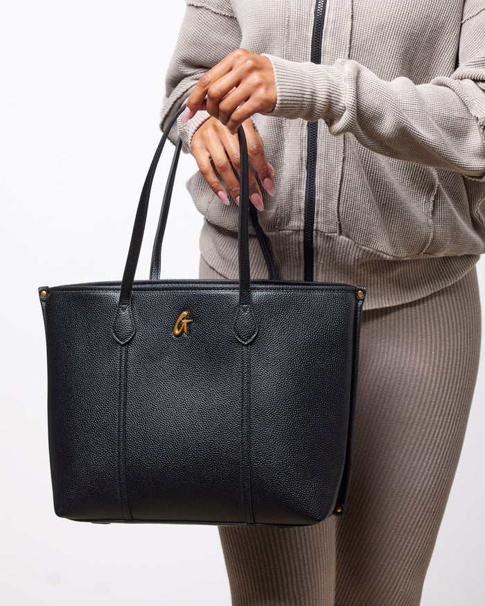 Black Pebble Sleek Tote featuring a textured finish and gold logo, perfect for stylish everyday use.