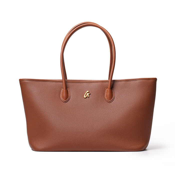 Brown pebble tote bag with dual handles and a small gold logo, stylish and spacious for everyday use.