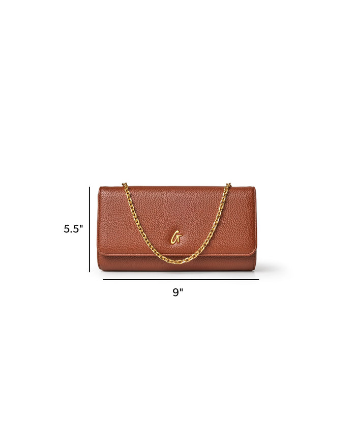 Brown Pebble Travel WOC handbag with a gold chain strap, measuring 9 inches wide and 5.5 inches tall.