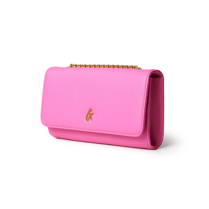 Pink Pebble Travel Wallet with a gold chain and a gold "G" logo, designed for travel essentials.
