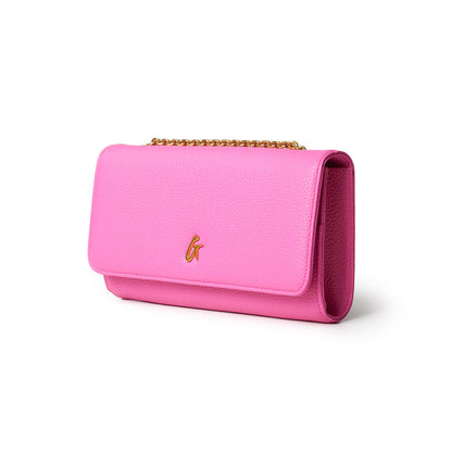Pink Pebble Travel Wallet with a gold chain and a gold "G" logo, designed for travel essentials.