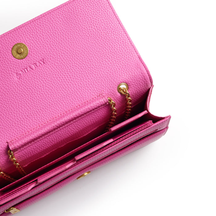 Open pink Pebble Travel Wallet with gold chain detail, multiple card slots, and textured leather surface on a white background.