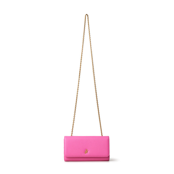 Pink Pebble Travel Wallet on a gold chain, designed for travel essentials, with a small gold logo on the front.