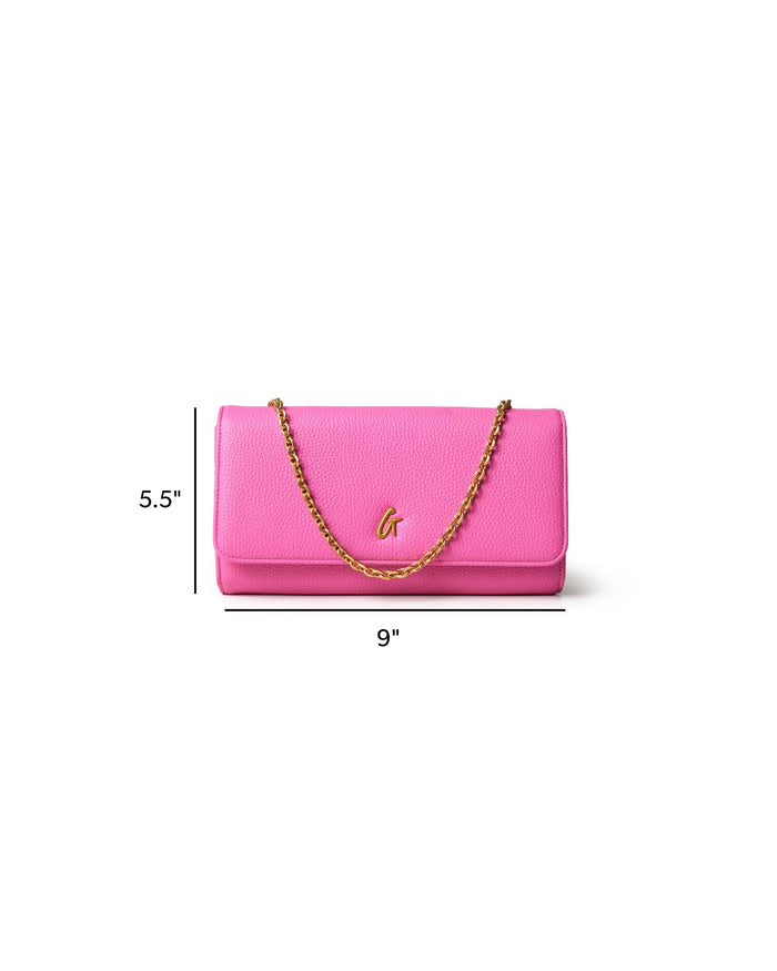 Hot pink Pebble Travel WOC handbag with a gold chain strap, measuring 9 inches wide and 5.5 inches tall.