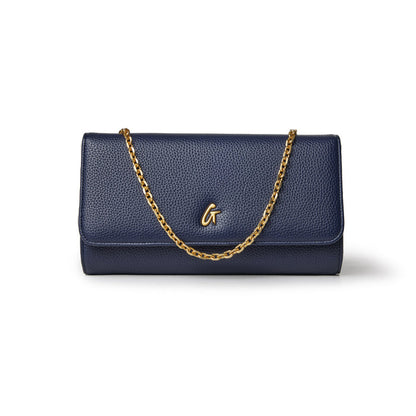 Navy blue Pebble Travel Wallet with a gold chain strap and a gold "G" logo on the front.