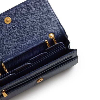 Navy Pebble Travel Wallet with gold chain details and multiple card slots, shown open against a white background.