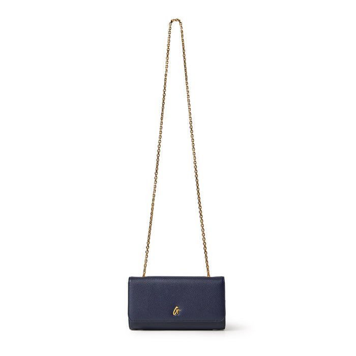 Navy Pebble Travel Wallet on Chain with gold chain strap and small gold logo, designed for travel and everyday use.