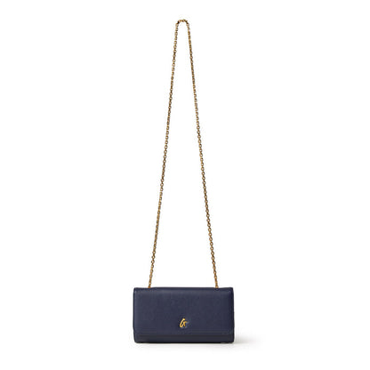 Navy Pebble Travel Wallet on Chain with gold chain strap and small gold logo, designed for travel and everyday use.