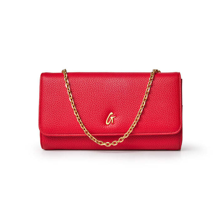 Red Pebble Travel Wallet with a gold chain and a gold "G" logo on the front, designed for travel and organization.