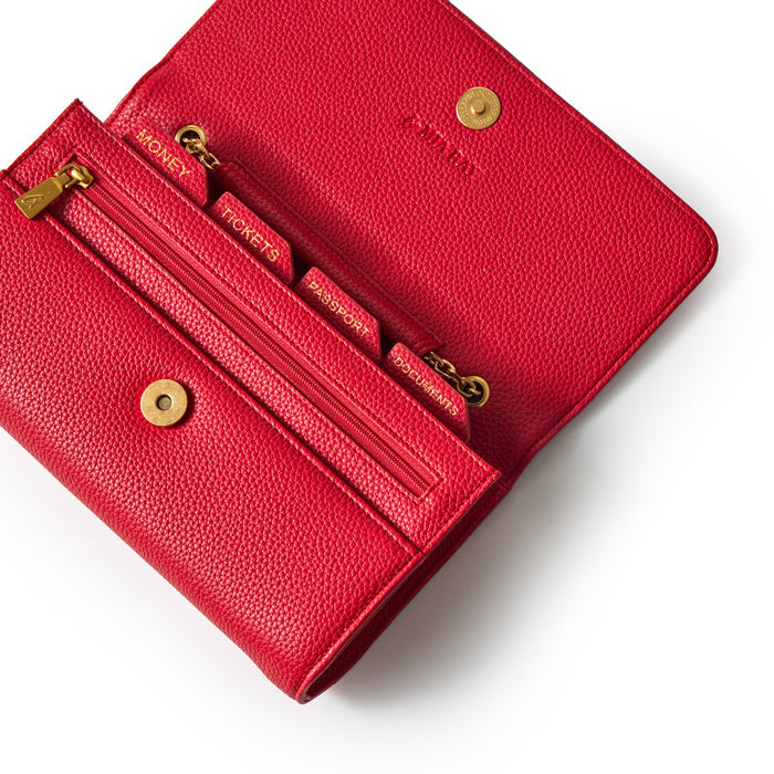 Red Pebble Travel Wallet with multiple compartments for cards, zipper pocket, and gold snap closure on textured leather.