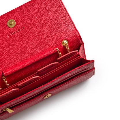 Red Pebble Travel Wallet with gold chain details, multiple compartments, and textured leather interior.