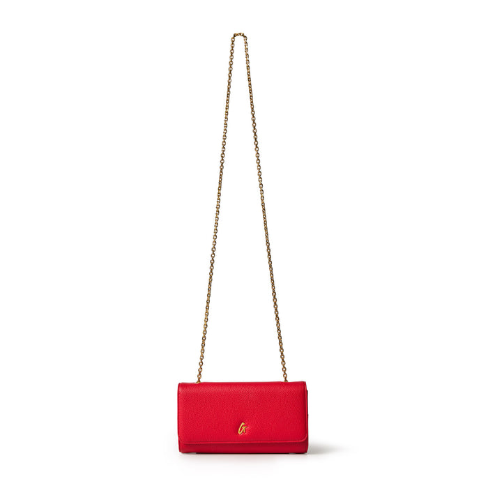 Red Pebble Travel Wallet on a gold chain, designed for travel and stylish storage, with a textured finish and gold logo.