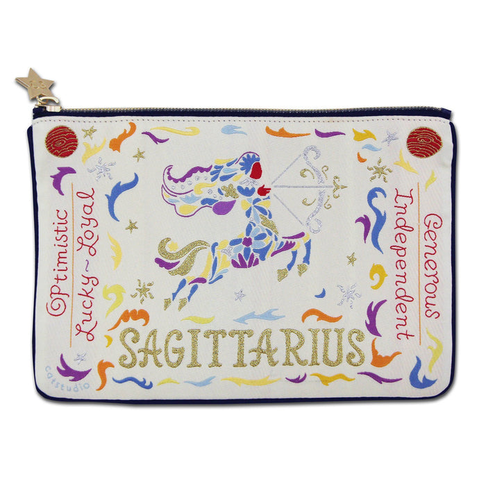 An embroidered zip pouch with gold embellishments and Sagittarius themed designs