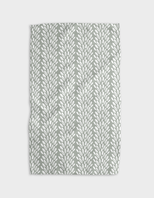 A gray tea towel with a geometric pattern of interlinked circles displayed on a white background.