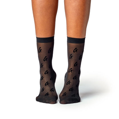 Black sheer logo socks featuring a transparent design with black "G" logos and a solid black band at the top.