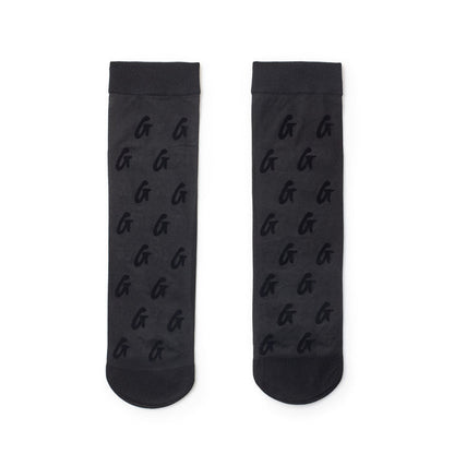 Black sheer logo socks with a repeating G logo pattern, featuring a sheer, semi-transparent design.
