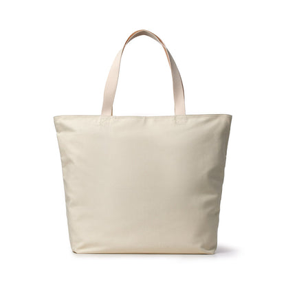 Hot pink canvas tote bag with signature logo, featuring sturdy handles and spacious interior for everyday use.