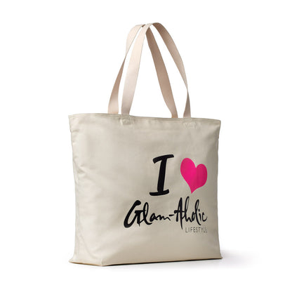 Hot pink and black text on a cream canvas tote bag with beige handles, featuring the phrase "I ♥ Glam-Aholic Lifestyle.