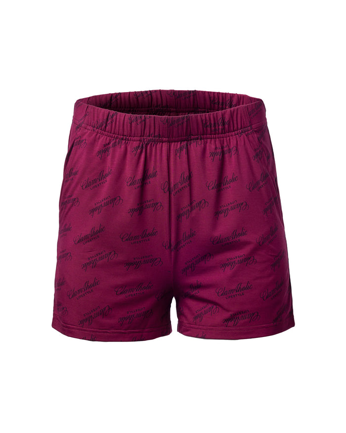 Burgundy pajama shorts featuring an all-over Glam-Aholic logo print, designed for stylish comfort at home.