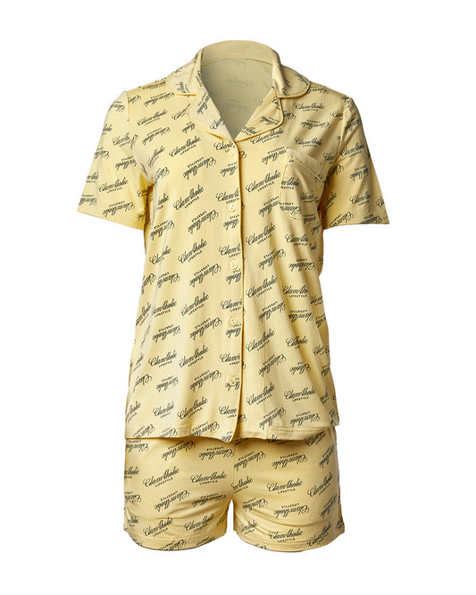 Yellow pajama short set featuring a stylish button-up top and matching shorts, adorned with a signature logo print.
