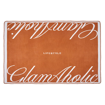 Brown luxury throw blanket with white script text reading "Chic Aholic" and "Lifestyle" on a white border.