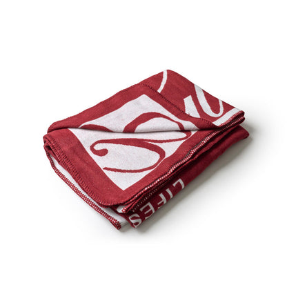 Burgundy throw blanket featuring a stylish logo design, perfect for adding luxury and comfort to any space.